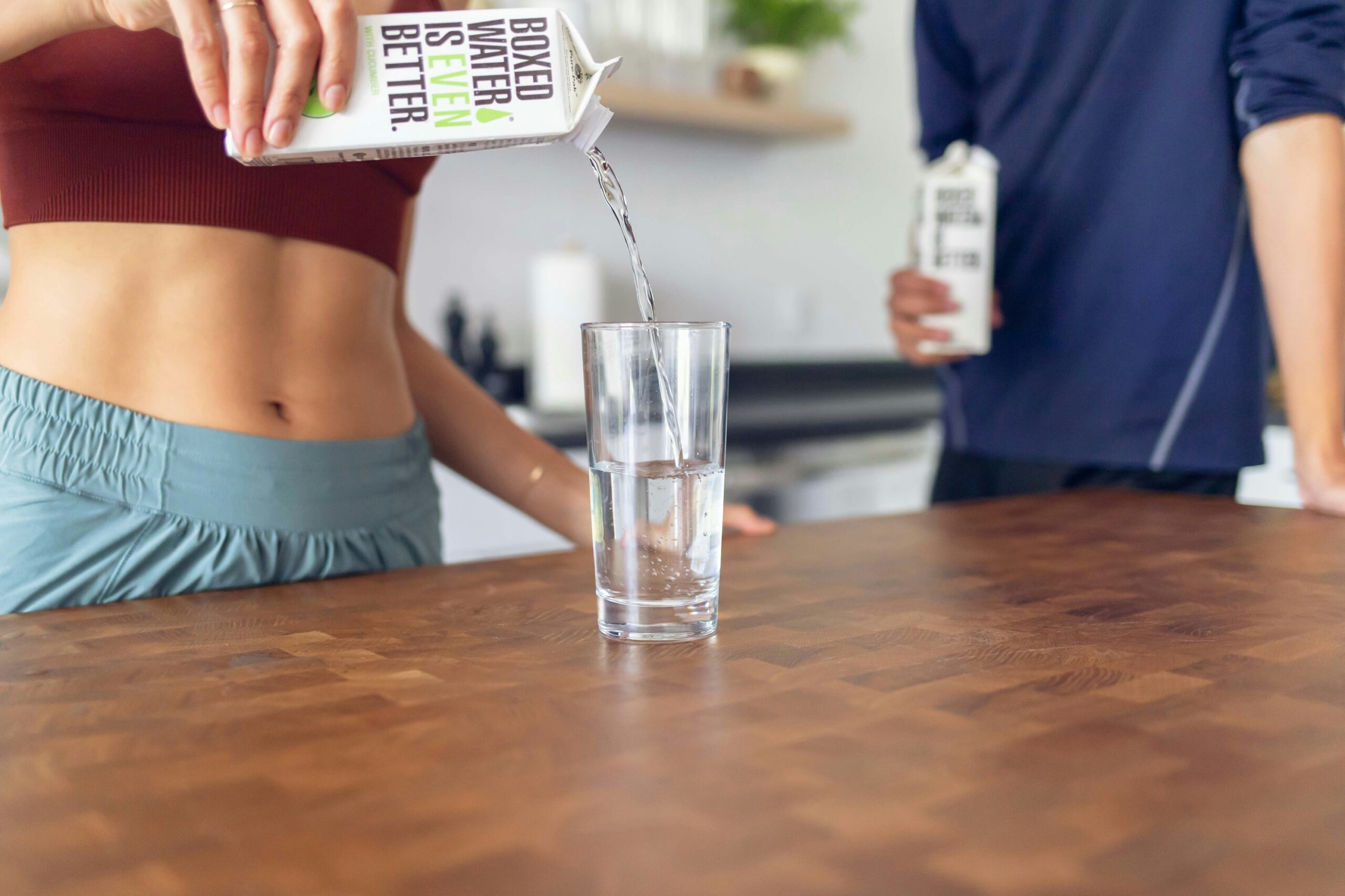 Active woman over 40 drinking water after workout – electrolytes for energy and recovery