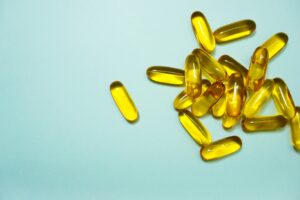 Fish Oil After 40 omega-3 capsules on Blue background